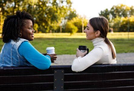 Two people sitting on a park bench