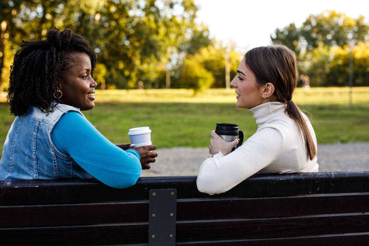 Two people sitting on a park bench