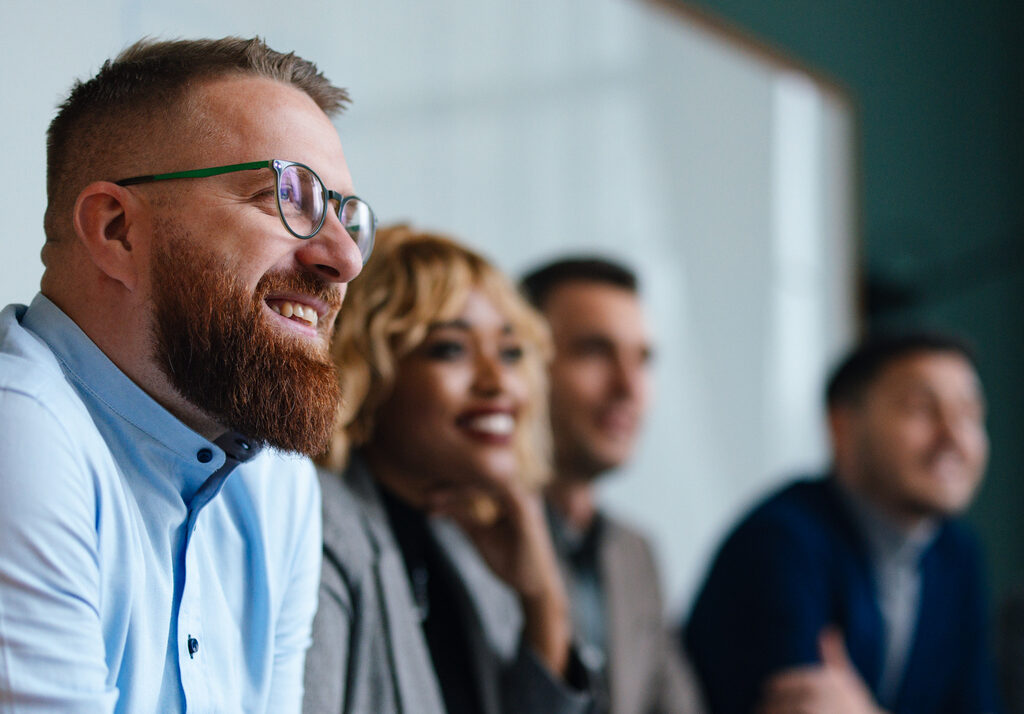 Businesspeople Listening To A Presentation In Their Office