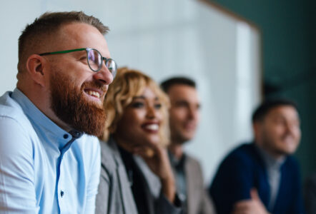 Businesspeople Listening To A Presentation In Their Office
