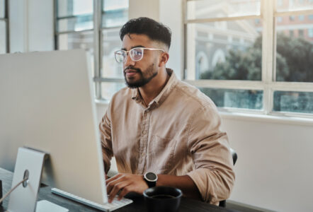 Information technology businessman working on computer in office for digital app, software development or website ux ui design. Young graphic designer with coding project or online company management