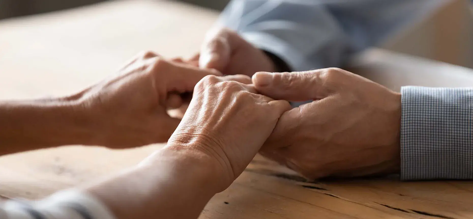 Two people holding each other hands
