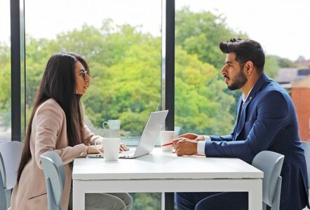 Man and woman talking at an office table