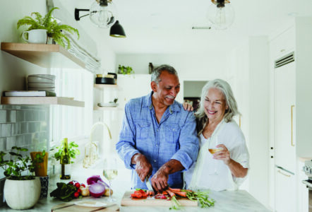 Couple in their 60s in the kitchen making dinner