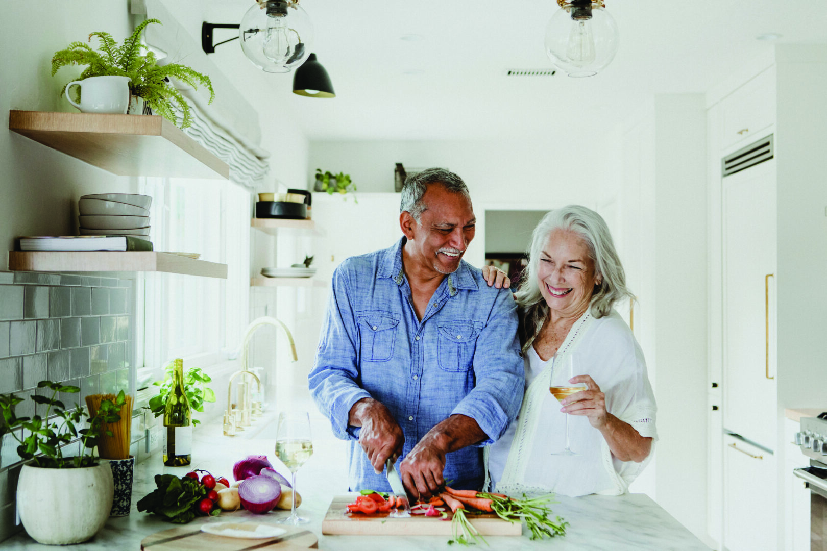 Couple in their 60s in the kitchen making dinner