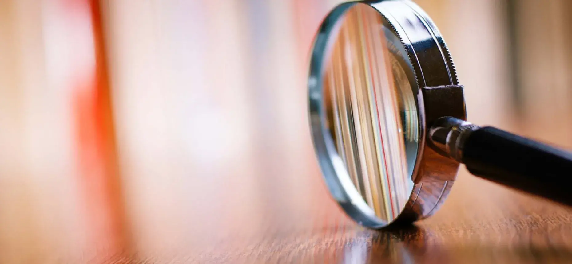 closeup photo of magnifying glass on desk