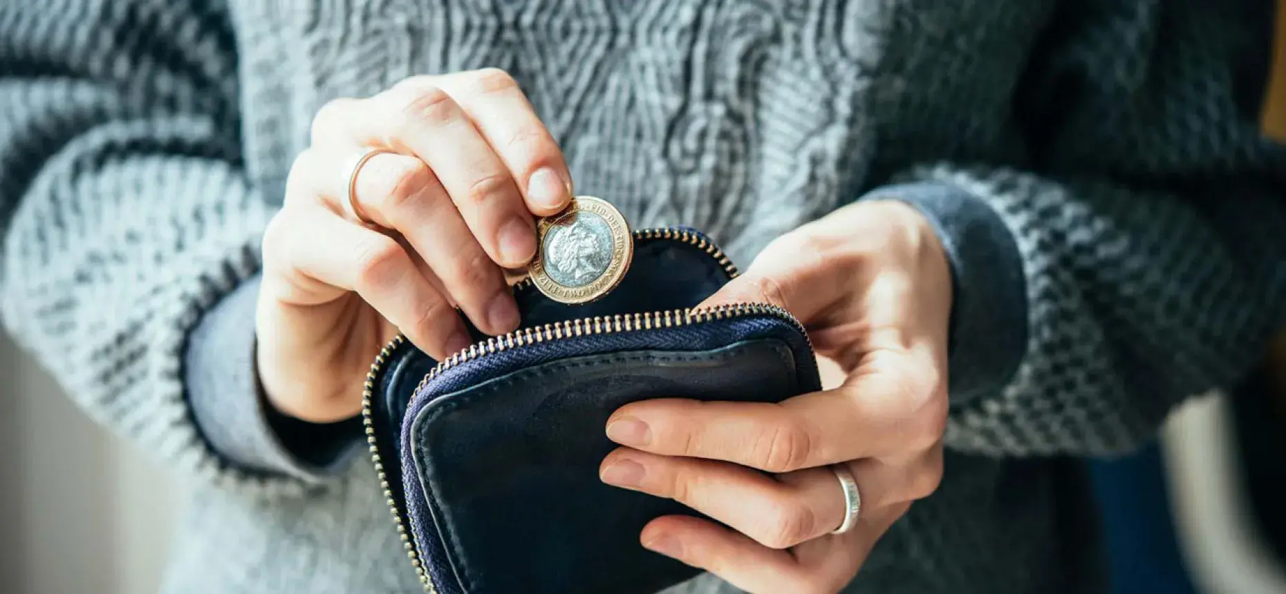 person placing coin in pouch