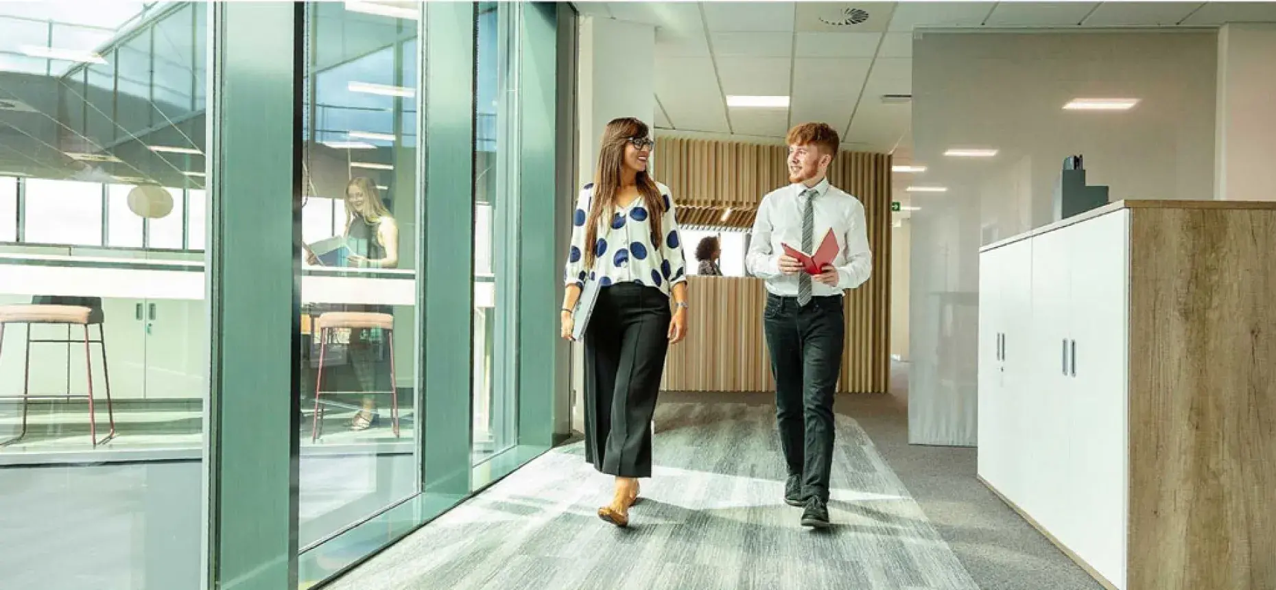 two employees walking through office