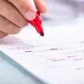 red pen highlighting text on white paper