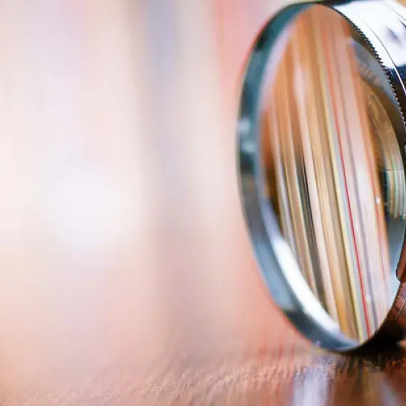 closeup photo of magnifying glass on desk