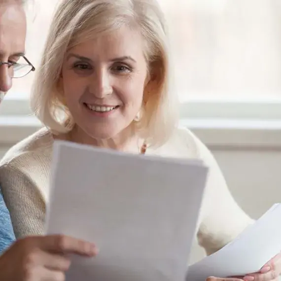 old couple looking at documents at home